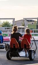 People racing in pedal go-karts