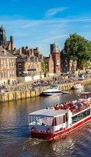 A cruise ship travelling down the River Ouse in York
