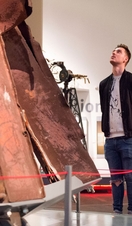 Two people looking upwards at an exhibit in Manchester Imperial War Museum