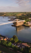 Landscape view of a suspension bridge over a river. 