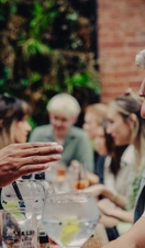 Groups of people sitting outside and drinking