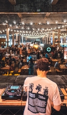 DJ playing to groups of people at Manchester Craft Beer Festival, in Depot Mayfield, Manchester