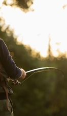 Man with backpack fly fishing