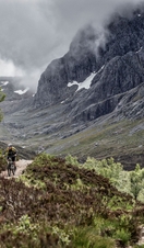 Two mountain bikers cycling on a trail going up a mountain