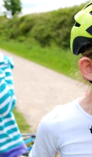 Two girls cycling on the Tissington and High Peak trail in the Peak District, UK.