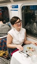 A group of people dining on the Supper Club Tube, a gourmet restaurant built into an underground tube train