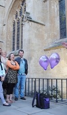 A performer standing on a speaker speaking to a crowd as part of Bizarre Bath