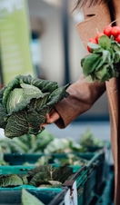 Woman shopping for fresh organic vegetables at farmer market