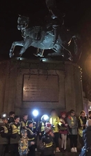 A group being taken on a nighttime ghost walk in Durham
