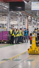 A group of people on a tour of the MINI car assembly plant in Oxford.