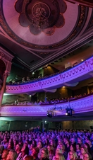 A crowd in the Grand Opera House York watching a performance