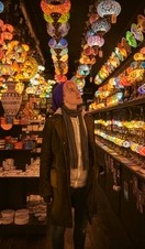One young woman standing in a lighting shop
