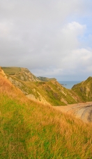 A couple walking on the clifftop in Dorset