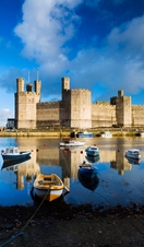 Row boats in a moat surrounding a castle