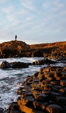 Sunset over the red basalt column. Sea views