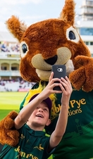 A child posing with a squirrel masket at Trent Bridge on a cricket family day out