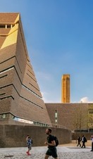 View of Tate Modern building with people walking by