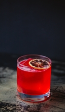 Glass with red coloured drink