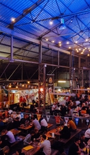 A high view of people eating a drinking at tables at Dockyard Social, Glasgow