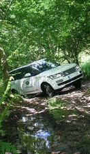 A Land Rover being driven over an off-road track near Exeter