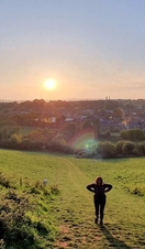 A woman looking out across Ludwell Valley Park in Exeter