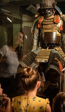 A group of people looking at a historic exhibition in RAMM, Exeter
