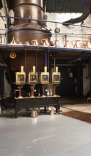 Distillery machines lining the wall at Plymouth Gin