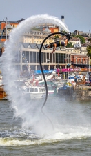A man riding a jetstream of water into the air as part of Bristol Harbour Festival