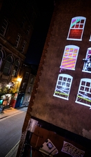 Artwork lit up on a wall in Bristol as part of Bristol Light Festival