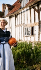 A lady standing outside Mary Arden's Farm
