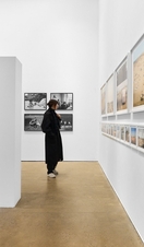 A woman admiring work at a photography exhibition. 