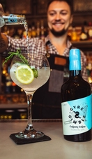 A bartender pouring a cocktail with coastal gin at Gyre & Gimble in Norwich
