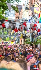 Crowds of people walking along Manchester's Canal Street