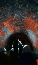 A tour group being guided through a tunnel underneath Dudley Canal