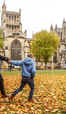 A woman and child walking outside Bristol Cathedral