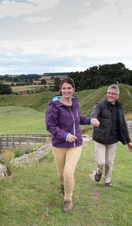 A couple walking along the ruins of Castle Rising West in Norfolk
