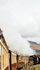 Woman looking out of window of traditional railway train