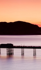 Pier built out into the sea in grand Edwardian style at dusk