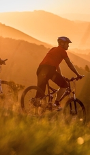 Two men on mountain bikes cycling at Devil's Dyke. Sunrise