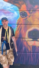 A tour guide highlighting Brighton's graffitti art on a tour