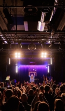 A live performance on stage at Band on the Wall in Manchester