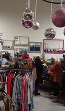 Groups of people searching through clothing at the Green Heart Collective in Grainger Market, Newcastle