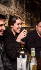 A group of people having a drink in an underground cellar in Edinburgh’s Old Town