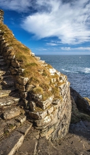 Whaligoe steps - steep stony stairs leads all the way down to the small beach below high cliffs near Whaligoe village, Highlands of Scotland.