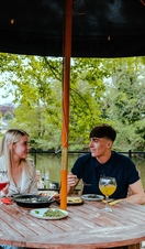 A couple dining by a river