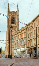 People walking down a street with a cathedral