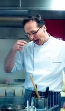 A chef tasting prepared food in Gauthier Soho, a high-end restaurant in London