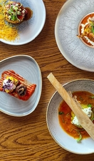 Various dishes served on a table at Prashad Restaurant in Leeds