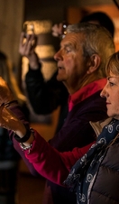 Group of people viewing glasses of whisky at Talisker Distillery 