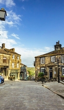 A view down a traditional cobbled street with a telephone box in view